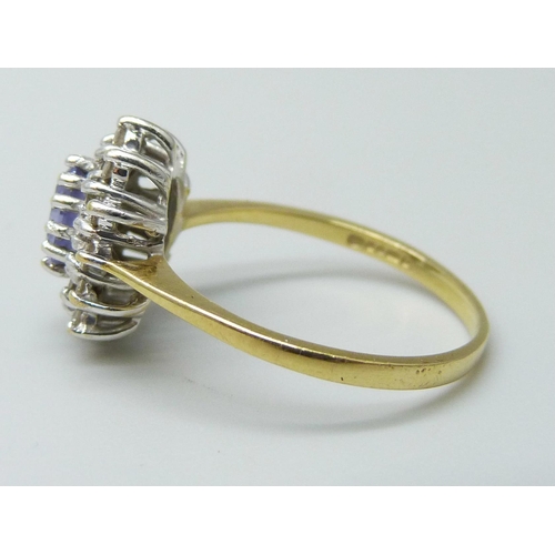 7021 - An 18ct gold, iolite and diamond cluster ring, 2.8g, M/N