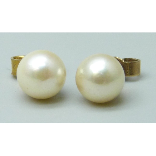 7024 - A pair of 9ct gold and pearl stud earrings, 1.2g, together with two pairs of costume earrings