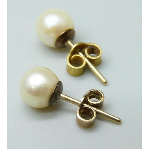 7024 - A pair of 9ct gold and pearl stud earrings, 1.2g, together with two pairs of costume earrings