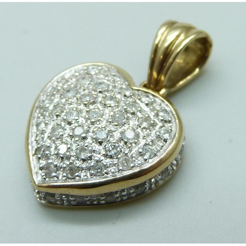 7029 - A 9ct gold heart shaped pendant set with 0.5ct of diamonds to front and edge, stamped .50 and hallma... 