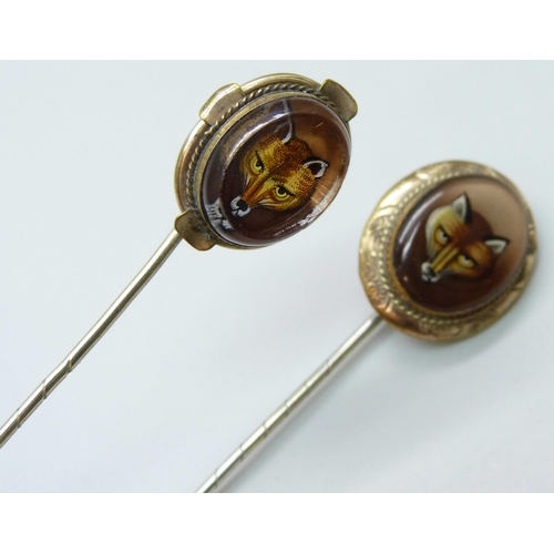 7030 - Two gilt metal stick pins with fox detail, largest top 2.1 x 1.8cm, both in fitted jewellery box