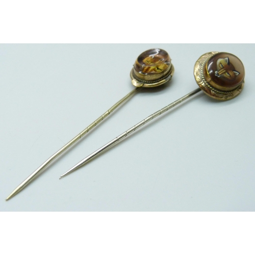 7030 - Two gilt metal stick pins with fox detail, largest top 2.1 x 1.8cm, both in fitted jewellery box