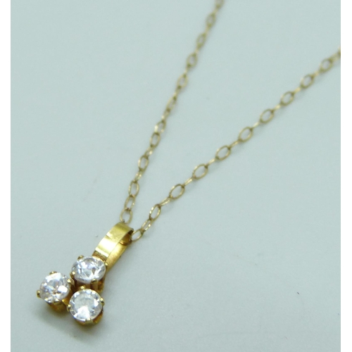 7035 - A yellow metal and white stone pendant on a 9ct gold chain, 0.7g, 40cm chain, 1cm pendant