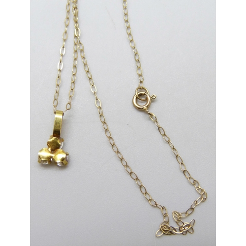 7035 - A yellow metal and white stone pendant on a 9ct gold chain, 0.7g, 40cm chain, 1cm pendant