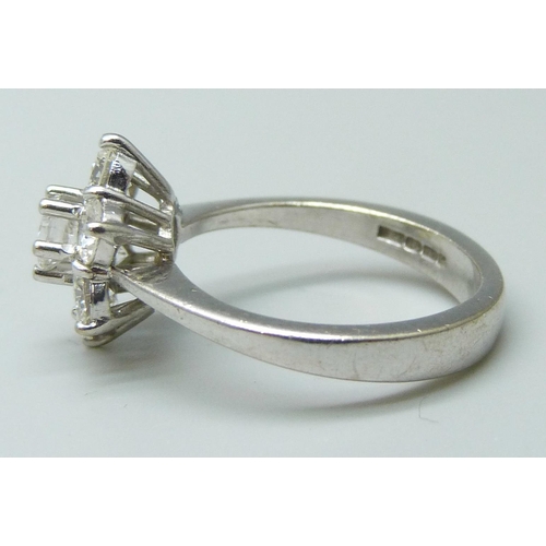 7040 - An 18ct white gold seven stone diamond cluster ring, approximately 0.7ct diamond weight, 4.6g, K