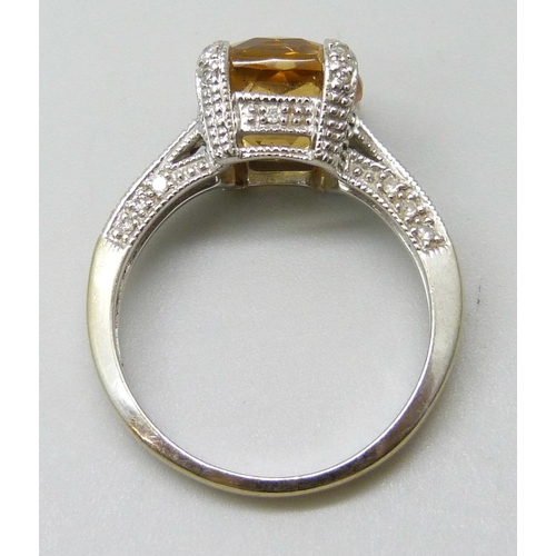 7047 - An 18ct gold ring set with a central citrine and diamond setting and shoulders, 5.5g, P