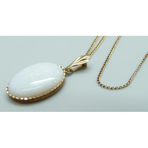 7056 - A yellow metal set opal pendant on a 9ct gold chain, 1.7g, 2.2cm including bale, 40cm chain