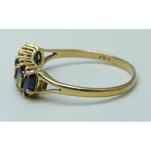 7057 - A 9ct gold, sapphire and diamond ring, 1.5g, N