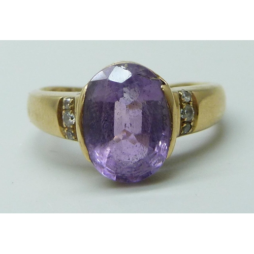 7064 - A 14k gold, amethyst and white stone set ring, 4.6g, N