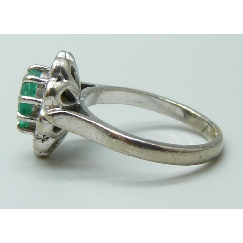 7082 - An 18ct white gold, emerald and diamond ring, approximately 0.7ct diamond weight, 7.4g, O/P