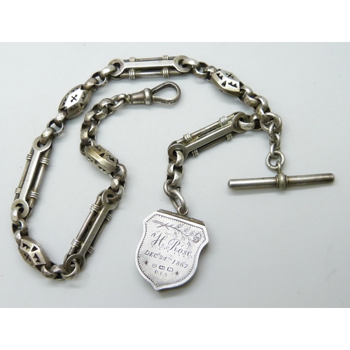 7089 - A Victorian white metal fancy link Albert watch chain, with a Victorian silver locket with enamelled... 