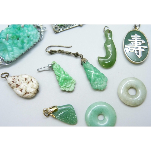 7095 - A collection of green stone jewellery including jade circles and other brooches, pendants and earrin... 