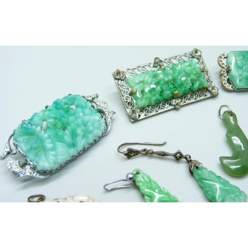 7095 - A collection of green stone jewellery including jade circles and other brooches, pendants and earrin... 