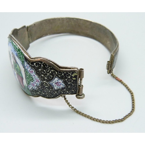 7103 - An Eastern enamelled bangle with a hand painted scene, 34g