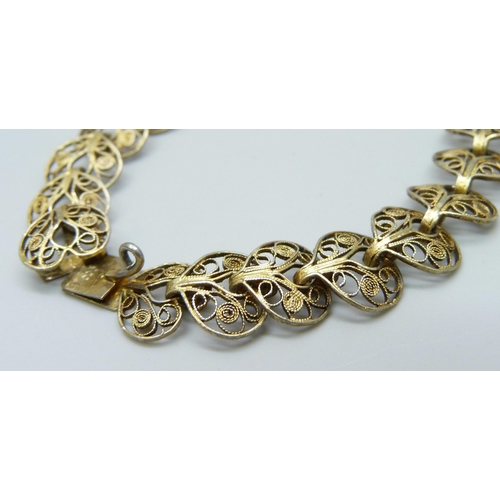 7109 - A .900 silver gilt Art Nouveau style filigree bracelet, 9.7g, 19cm