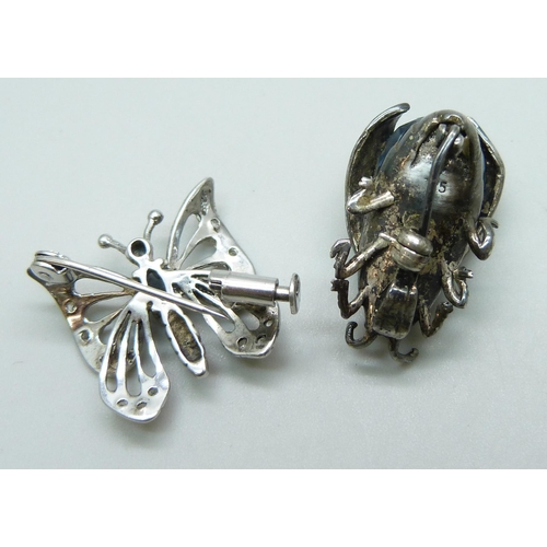 7114 - A paste set silver bug brooch, 2.5cm, and a silver butterfly brooch