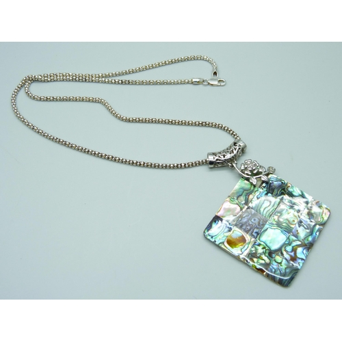 7124 - A large silver plated abalone pendant on a silver chain