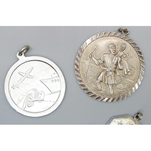 7126 - Five silver St Christopher pendants including a Georg Jensen enamelled example, and a silver cross, ... 