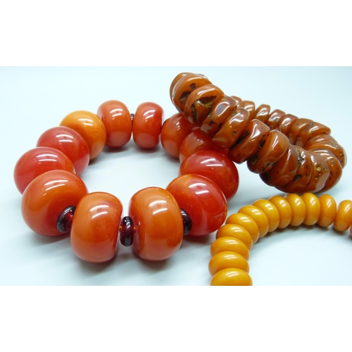 7141 - Three amber coloured beaded bracelets, 214g