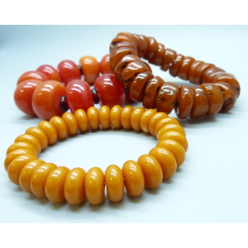 7141 - Three amber coloured beaded bracelets, 214g