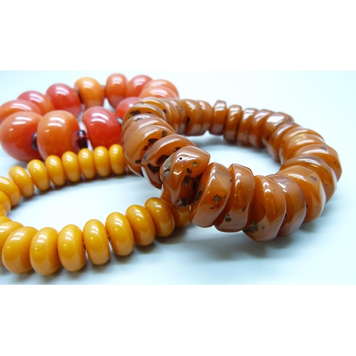 7141 - Three amber coloured beaded bracelets, 214g