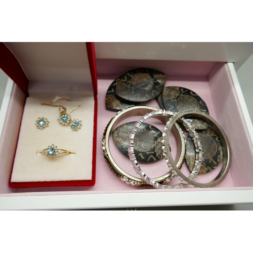 7146 - A jewellery box and contents including Hollywood and other brooches, Monet earrings, a silver bracel... 