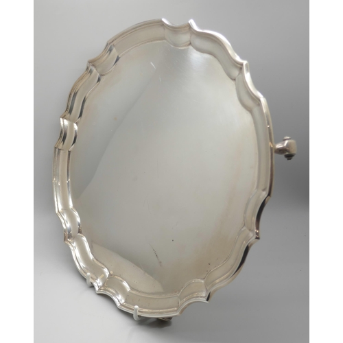 7233 - A silver salver with four feet, James Deakin & Sons, Sheffield 1933, 25.2cm, 580g