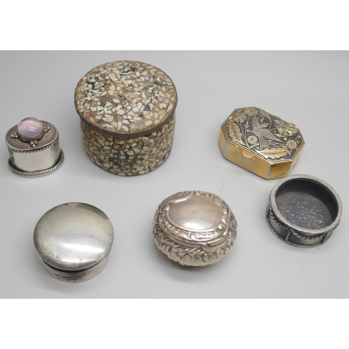 7249 - A Victorian embossed silver pill box, Birmingham 1895, another silver pill box, Birmingham 1919, and... 