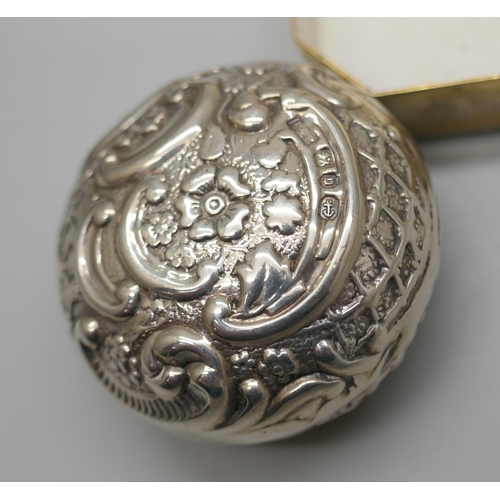 7249 - A Victorian embossed silver pill box, Birmingham 1895, another silver pill box, Birmingham 1919, and... 