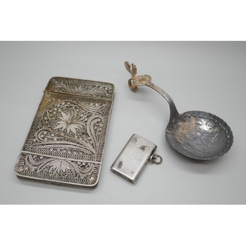 7250 - A white metal filigree card case, 10cm, a Dutch silver ladle and a silver vesta, 92g total, vesta a/... 