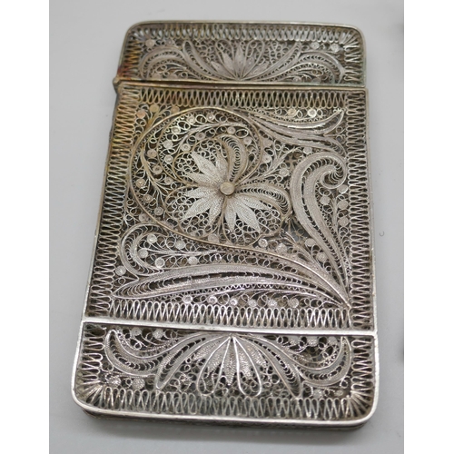 7250 - A white metal filigree card case, 10cm, a Dutch silver ladle and a silver vesta, 92g total, vesta a/... 