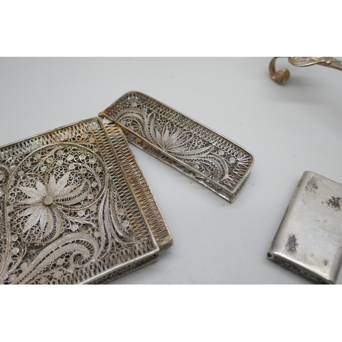 7250 - A white metal filigree card case, 10cm, a Dutch silver ladle and a silver vesta, 92g total, vesta a/... 