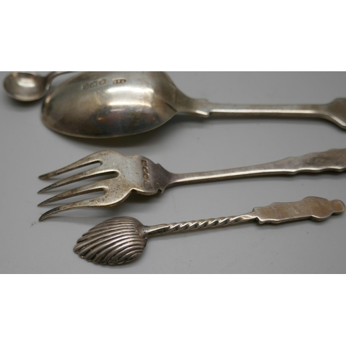 7258 - A collection of silver items including a pepper, spoons, fork, three thimbles, etc., 104g