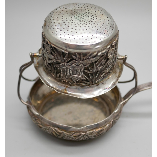 7260 - A white metal tea strainer with Chinese character marks to handle, 16cm, 64g