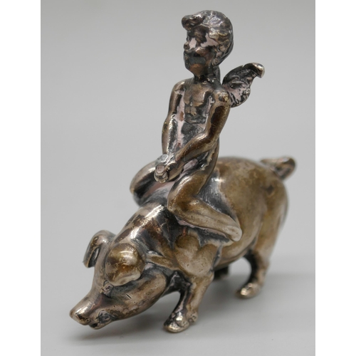 7261 - A small .800 silver model of a cherub riding a pig, 4cm, 26g