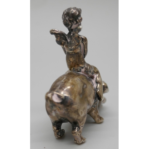 7261 - A small .800 silver model of a cherub riding a pig, 4cm, 26g