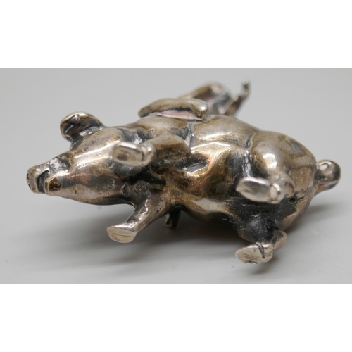 7261 - A small .800 silver model of a cherub riding a pig, 4cm, 26g