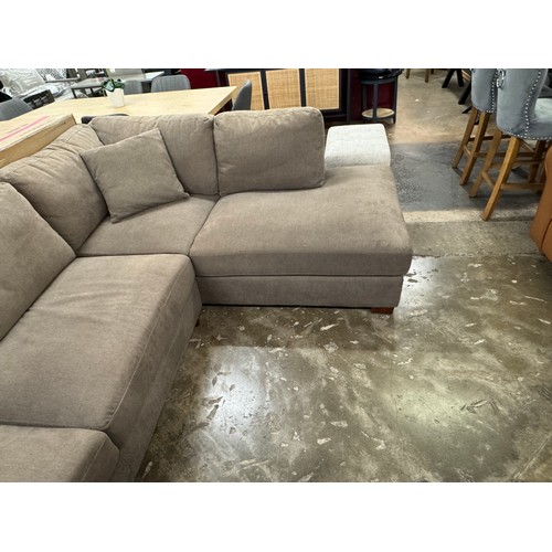 3023 - A brown fabric upholstered right hand facing corner sofa with footstool