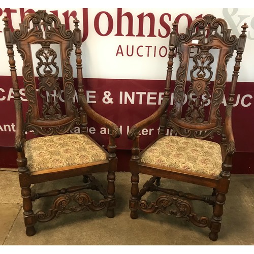 105 - A pair of Carolean style carved oak throne chairs