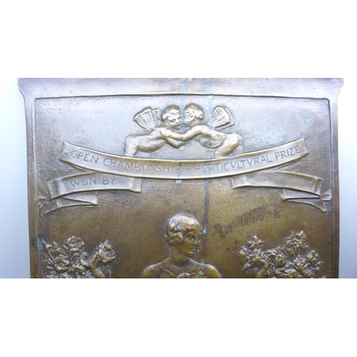 2002 - A bronze plaque depicting a lady, 