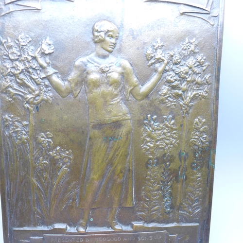 2002 - A bronze plaque depicting a lady, 