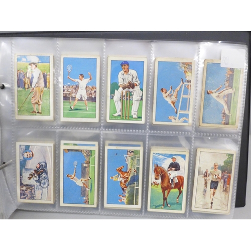 2017 - An album of sporting cigarette cards, including players 'Racing Caricatures', Footballers 1928, Cric... 