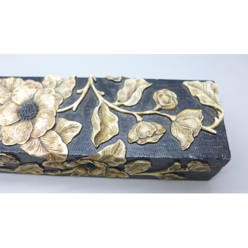 2192 - An oriental carved stone pen box with flower detail, 27.5cm