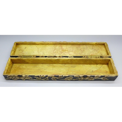 2192 - An oriental carved stone pen box with flower detail, 27.5cm