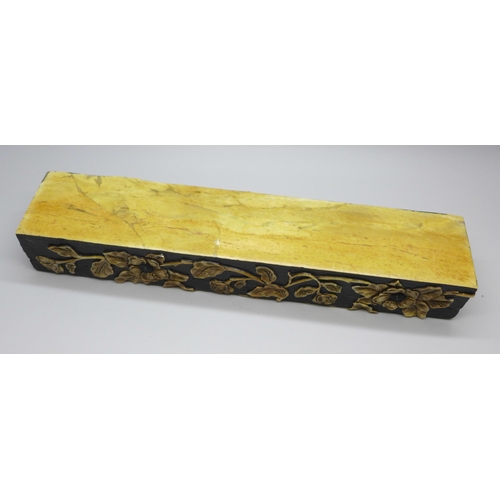 2192 - An oriental carved stone pen box with flower detail, 27.5cm