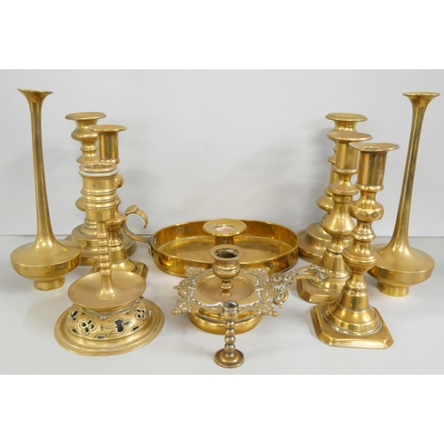 2214 - A collection of eight brass candlesticks (three matching pairs) with two chamber-sticks and another ... 