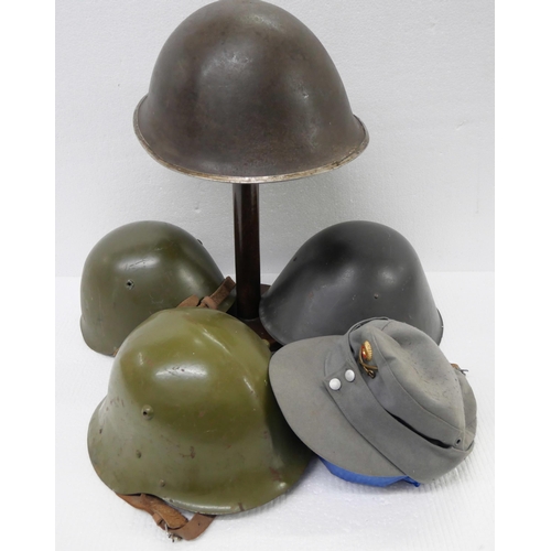 2217 - A collection of Militaria - four Military helmets and a cap