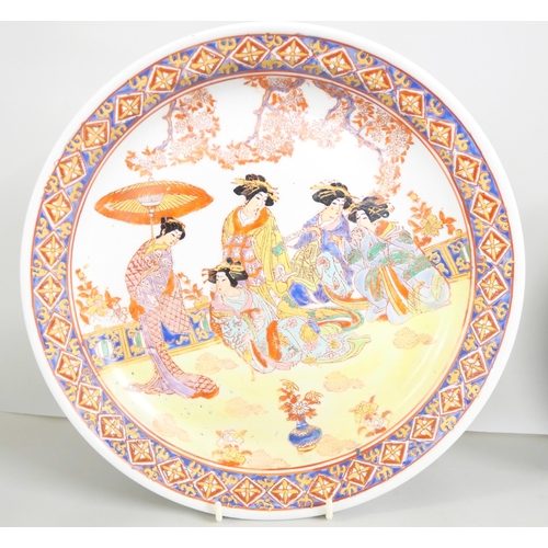 2219 - Two Japanese ceramic charger plates with central geisha scenes, and a Chinese dragon figure