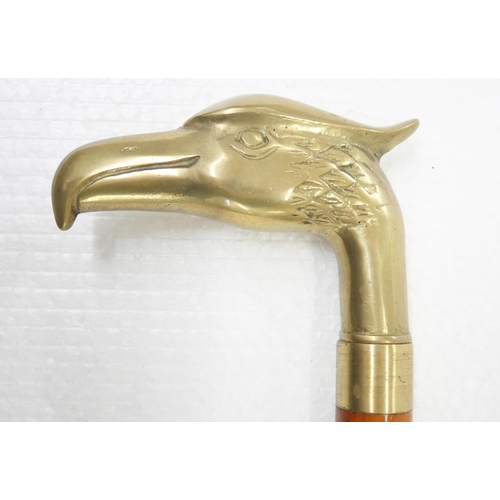 2244 - A wooden walking stick with brass eagle handle