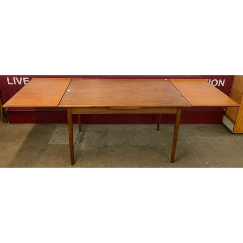 20 - A teak extending dining table